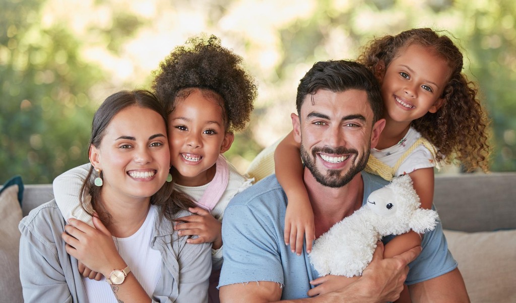 Smiling family of four outdoors
